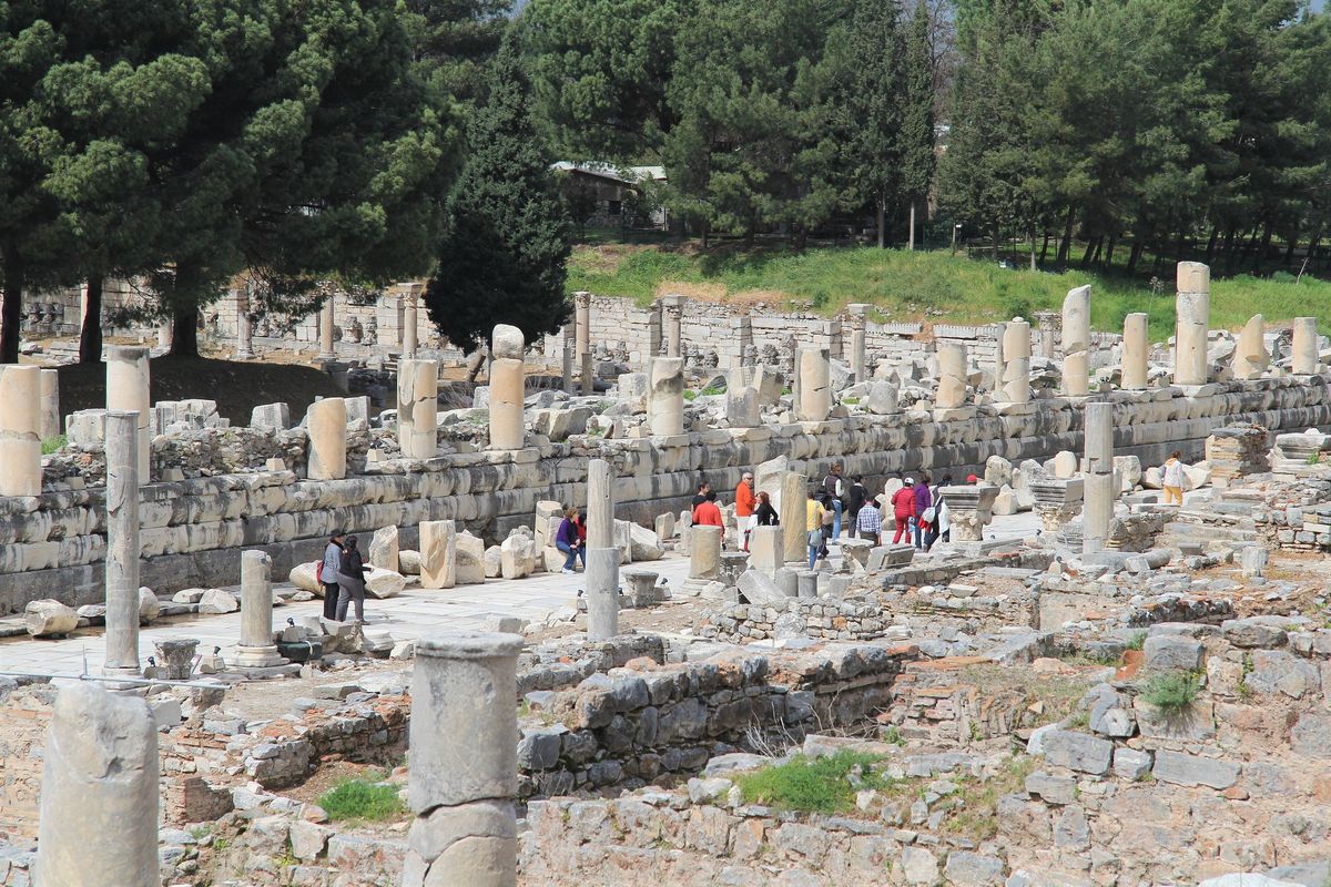 A small group of visitors among the columns and ruins along Marble Street at Ephesus in spring