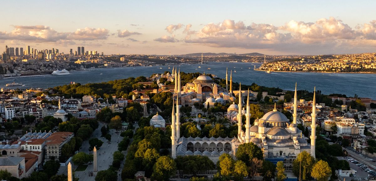 Aerial view of the Blue Mosque with Hagia Sophia just behind it and the Bosphorus beyond, Istanbul, at golden hour